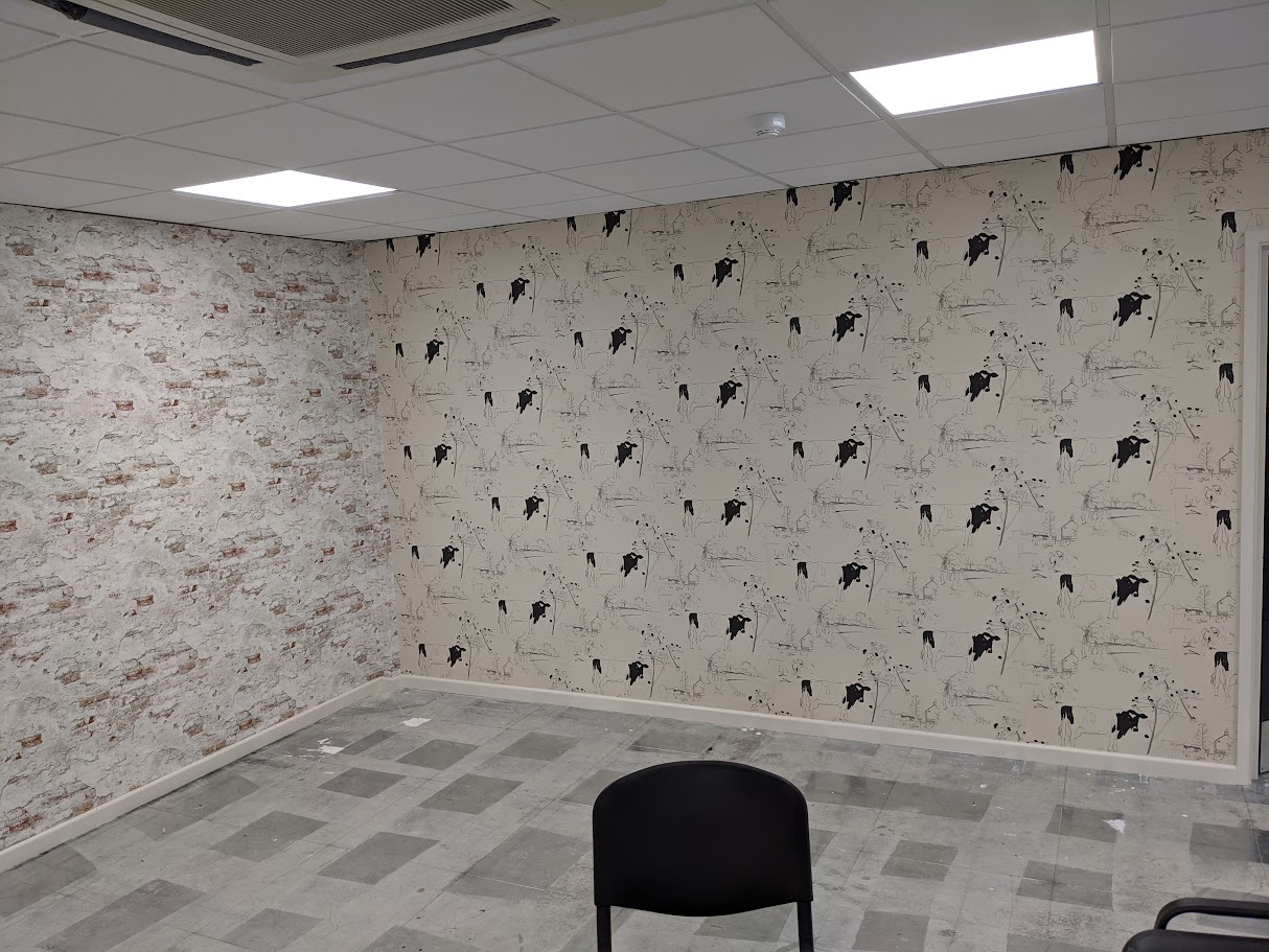 Installing an acoustic wallcovering in a meeting room for improved sound control