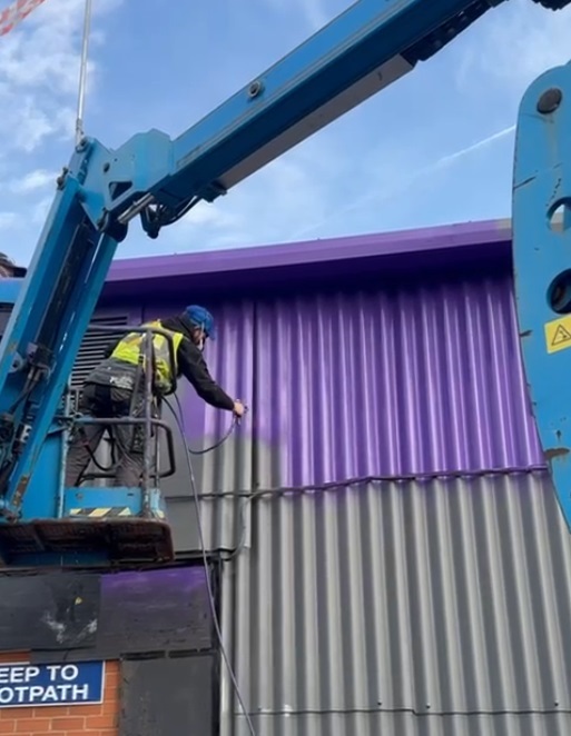 Airless spray painting walls in a commercial building in Sheffield