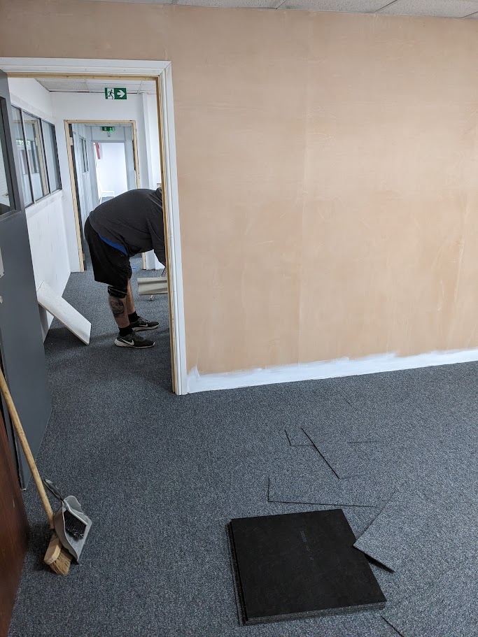 Carpet tile fitting with neat cuts around door frames and edges