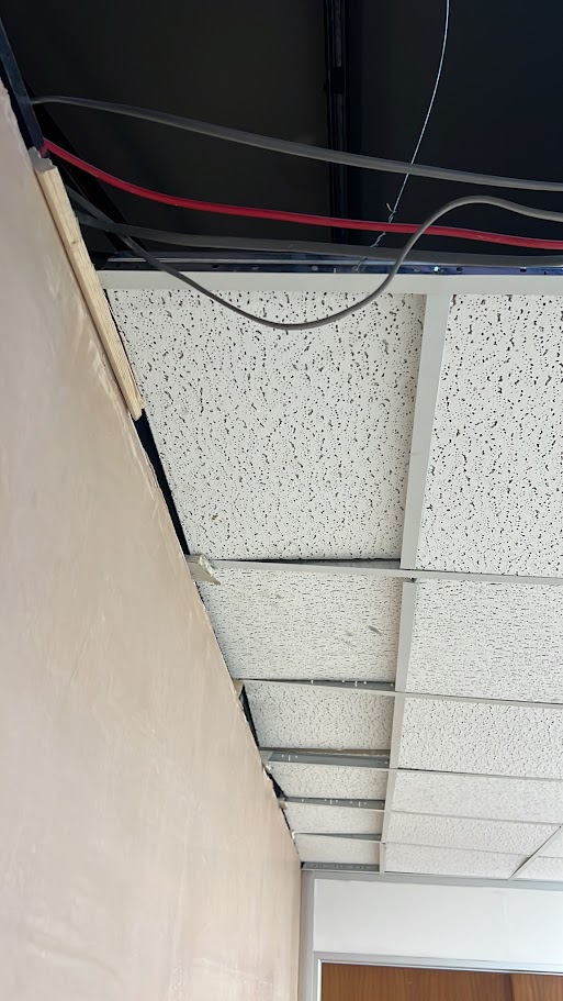 Replacing ceiling tiles during a commercial property maintenance visit