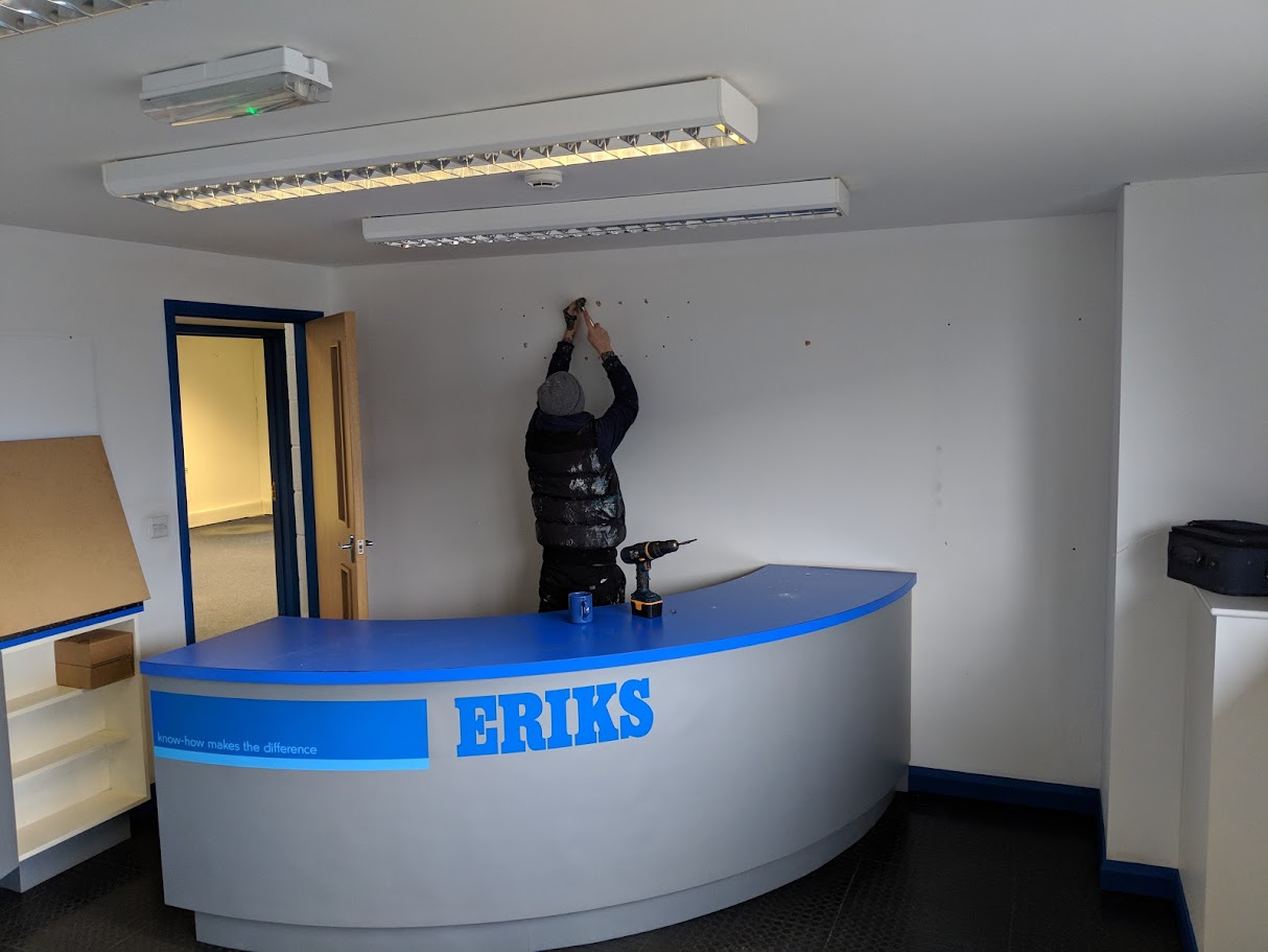 Commercial decorators repainting an office interior