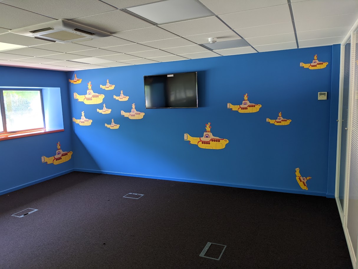 Commercial decorators painting and installing wall graphics in an office in Sheffield City Centre