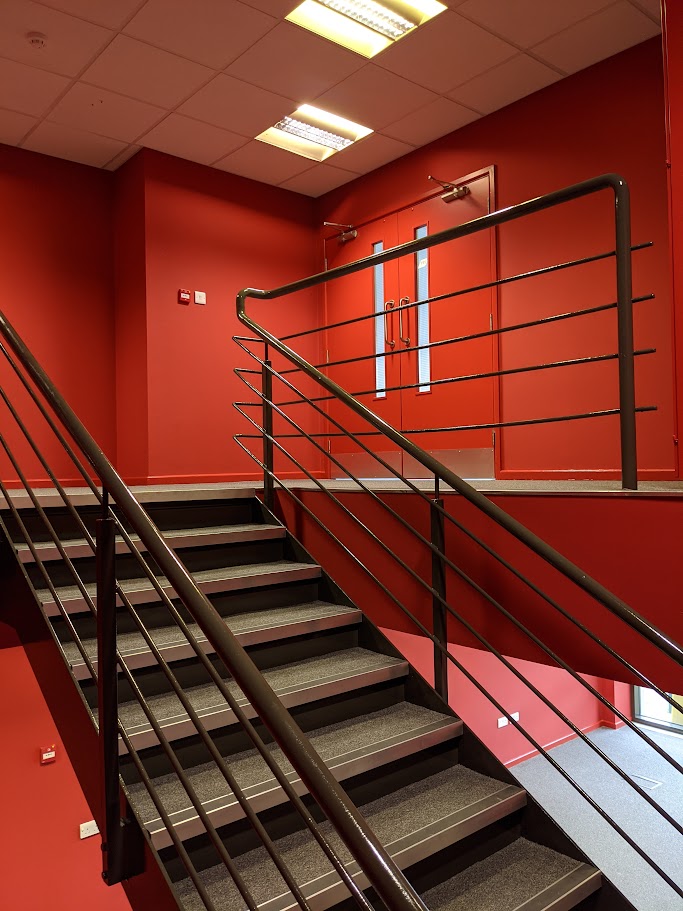 Commercial decorators painting a staircase in a commercial building in Sheffield
