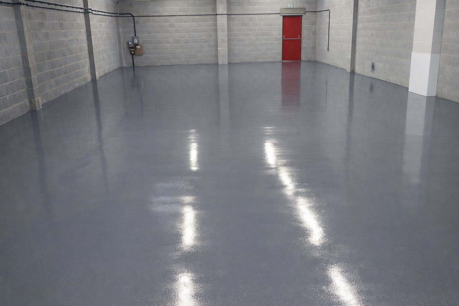 Applying an industrial coating system to a floor surface