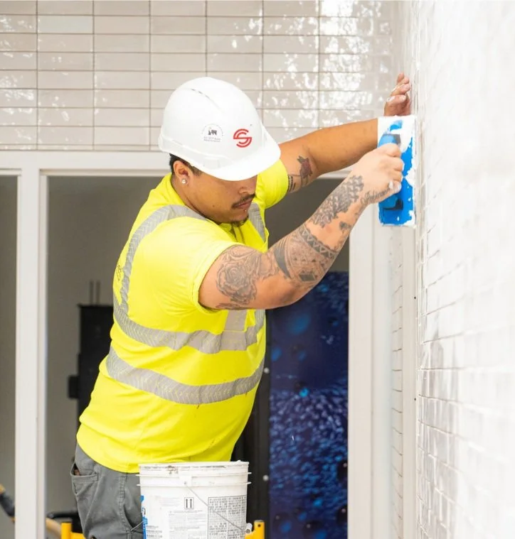 Commercial wall and floor tiling installation in washroom