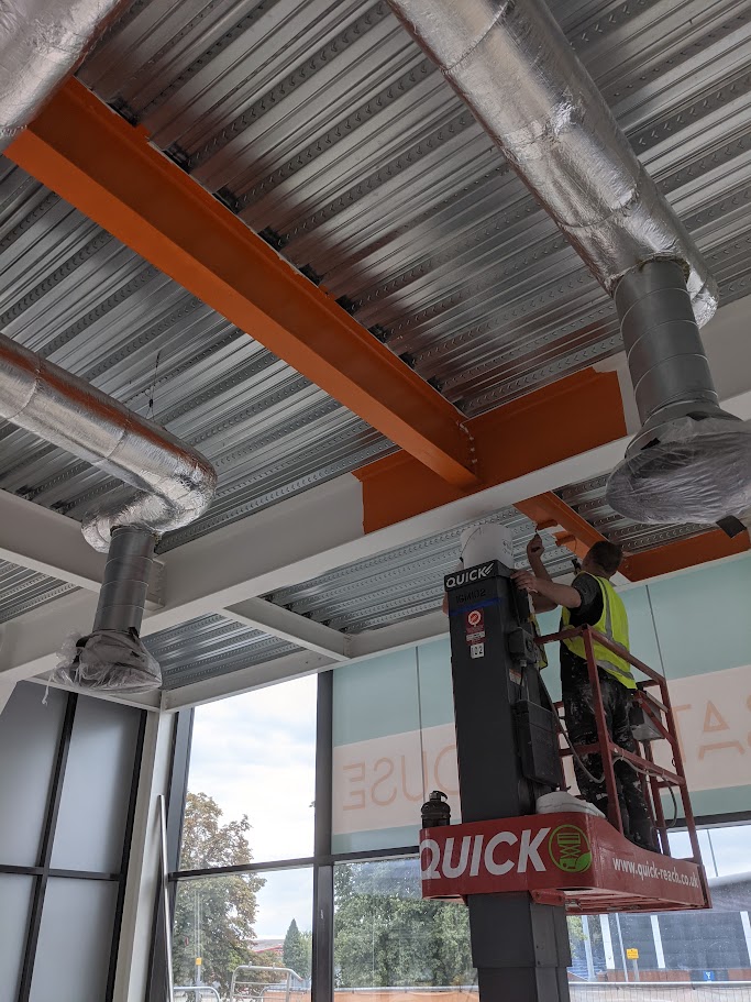 Applying protective coating to steelwork in an industrial building in Sheffield