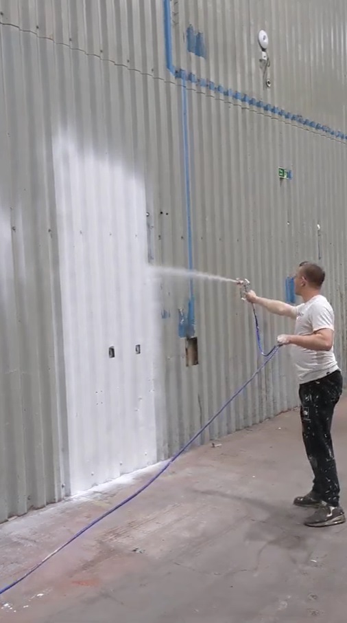 Spray painting large warehouse walls in South Yorkshire