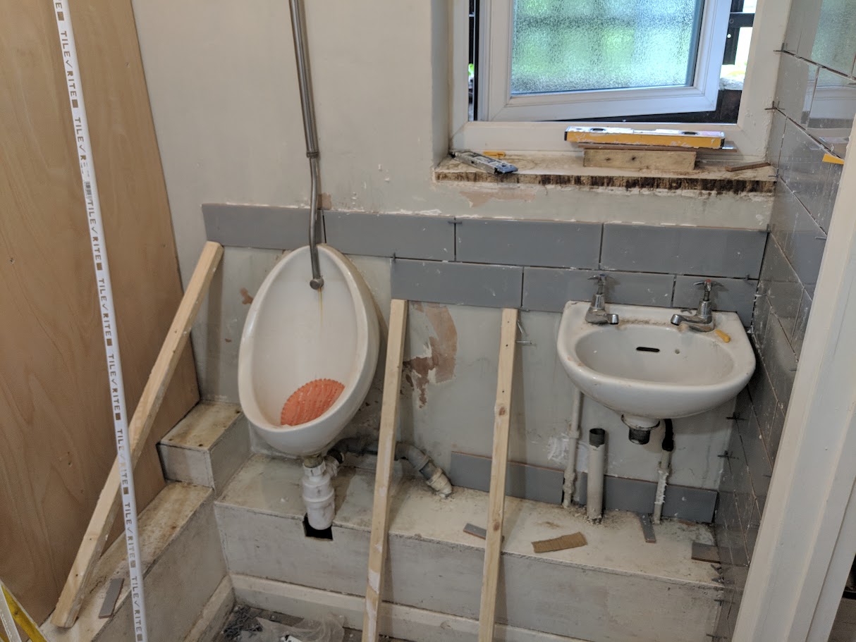 Commercial washroom plumbing works including basins and pipework